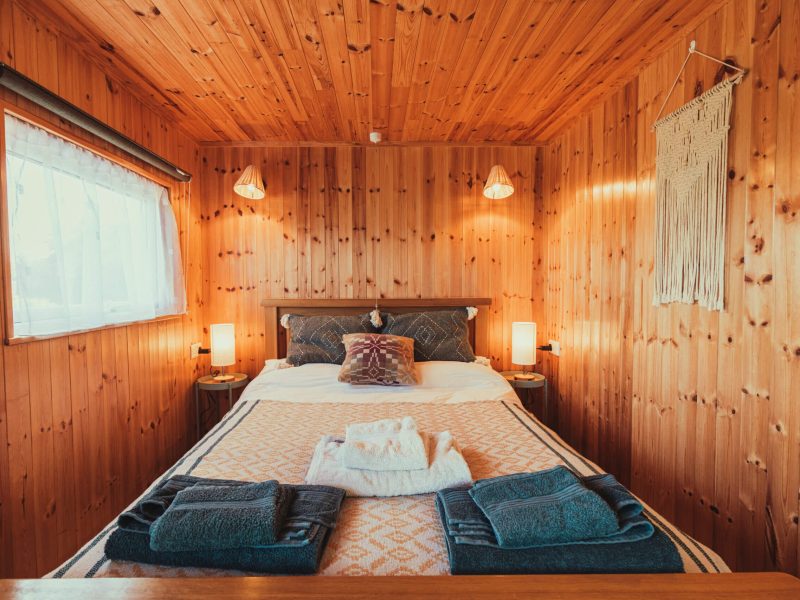 Comfortable bed in glamping cabin