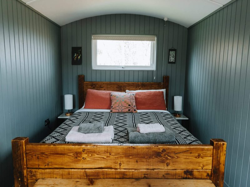 Luxury king size bed in glamping cabin